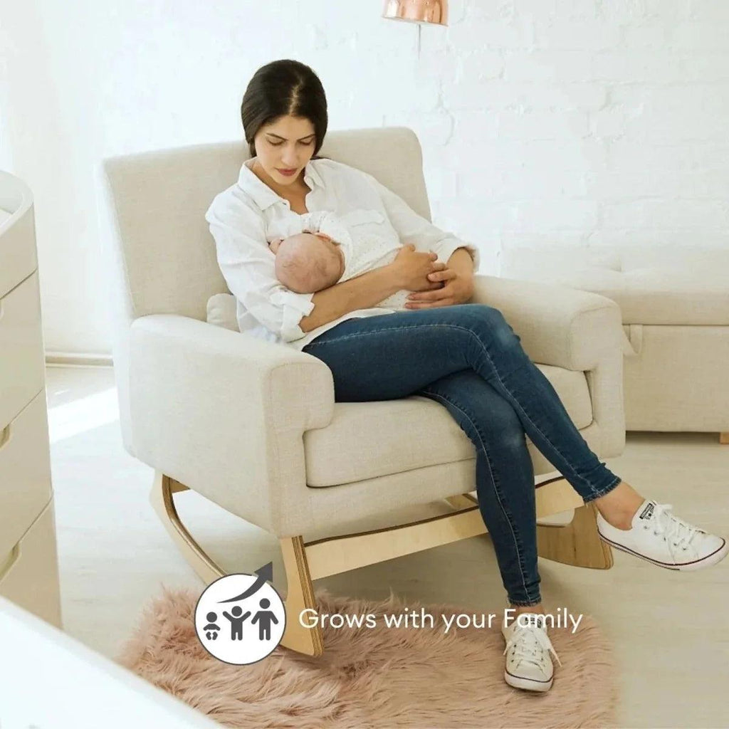 Oat nursing chair with cushioned arms and head support, used for baby feeding.