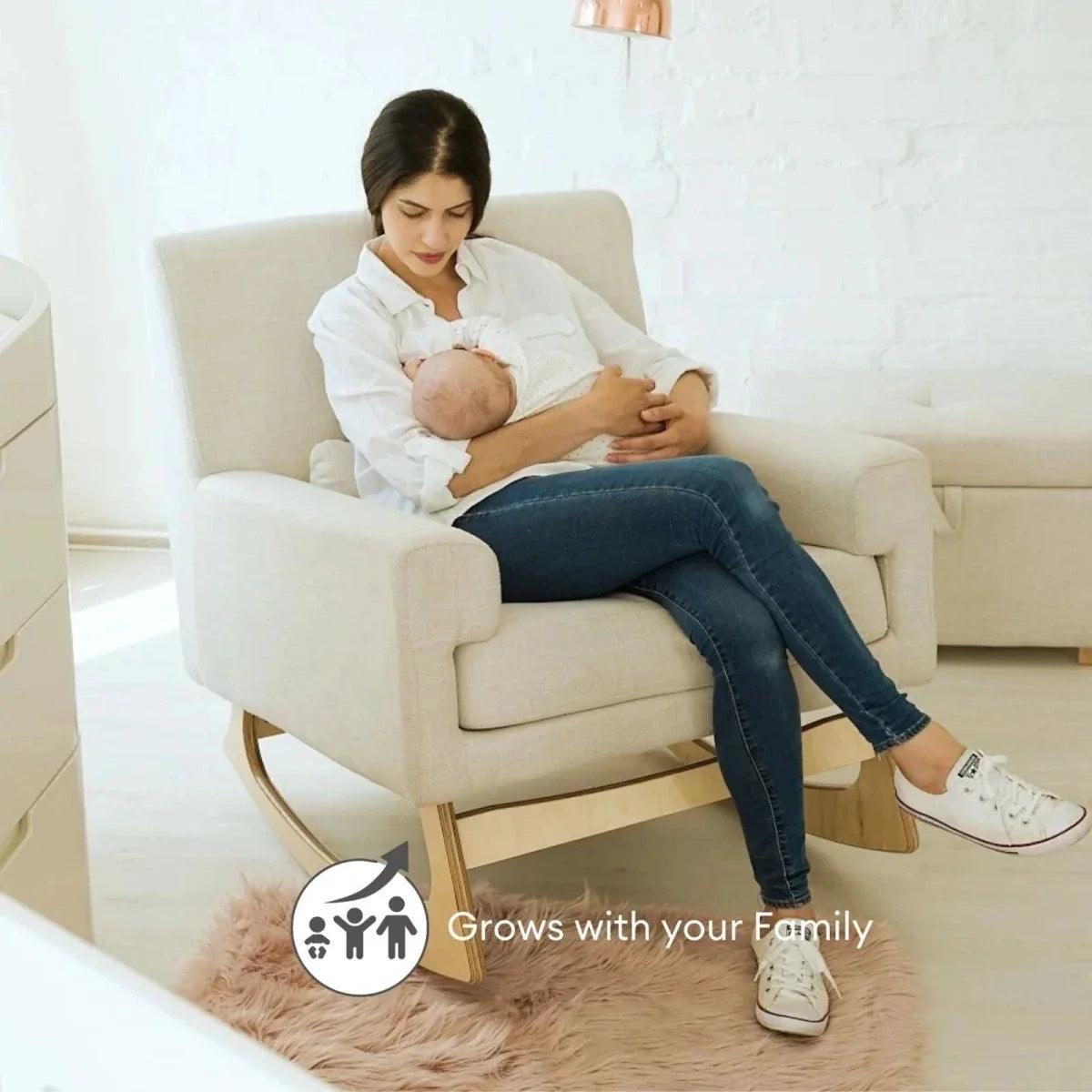 Oat nursing chair with cushioned arms and head support, used for baby feeding.