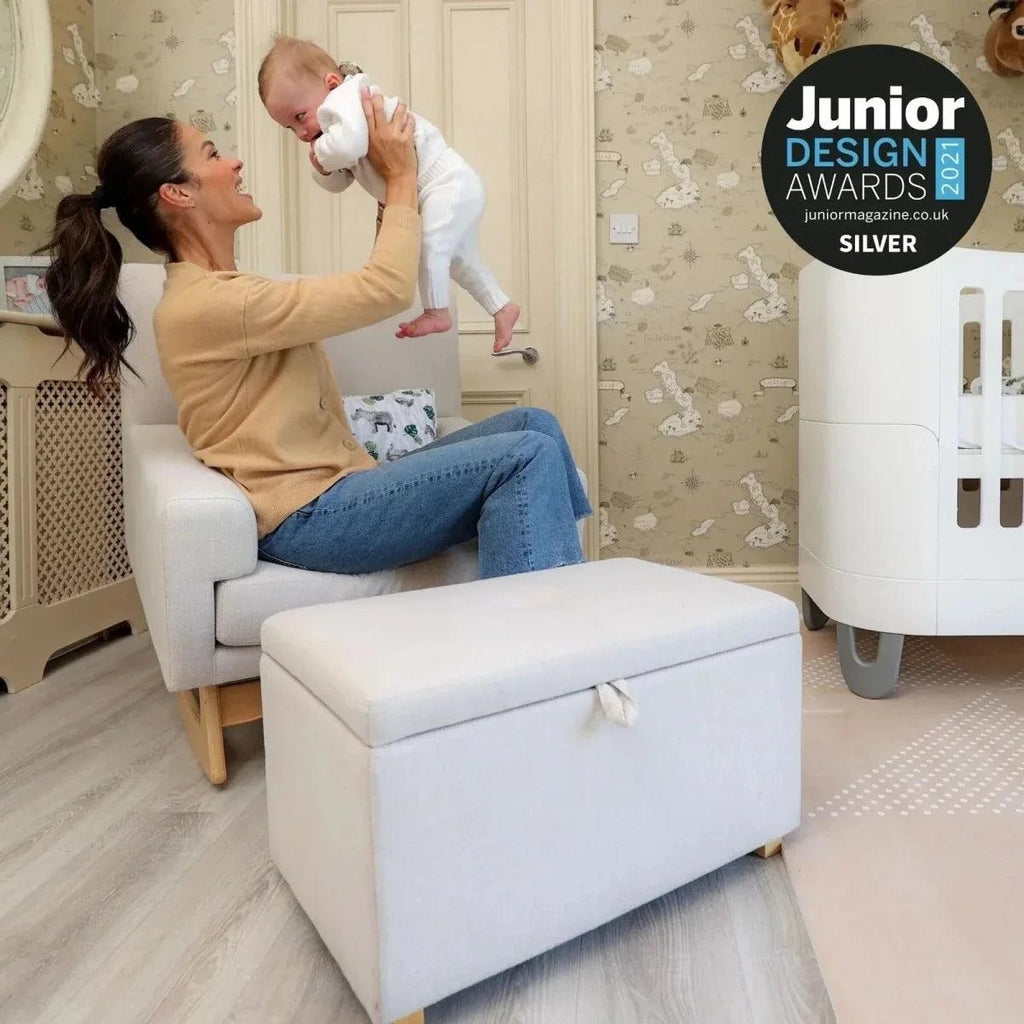 Oat nursing chair with matching footstool, cushioned seat and rounded rocker base.