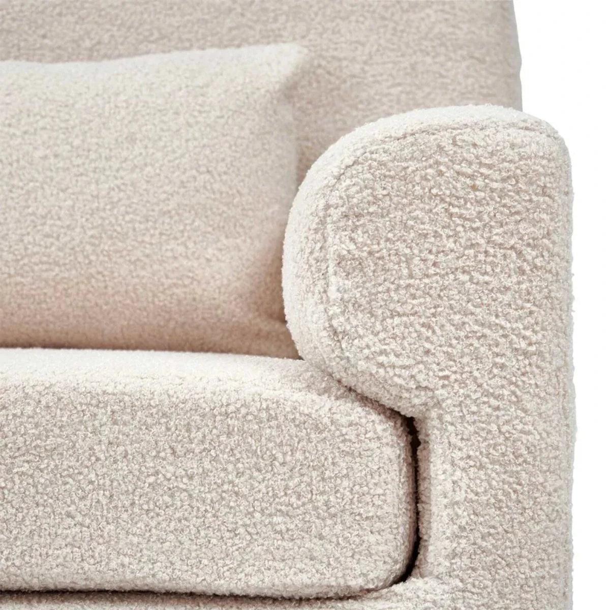 Beige boucle baby rocking chair close-up of rounded arm and textured upholstery