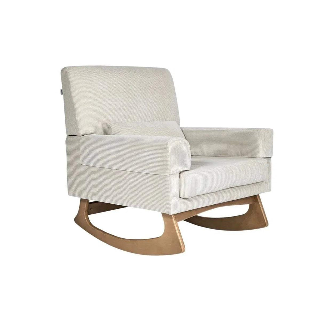 Light ecru upholstered rocking nursing chair with wide arms and rounded rocker base