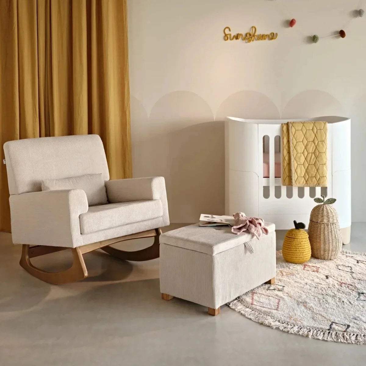 Ecru upholstered rocking nursing chair with integrated headrest and curved rocker base