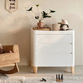 White and natural baby dresser with three drawers and solid wood legs