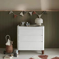 White baby dresser with 3 drawers and walnut-finished legs