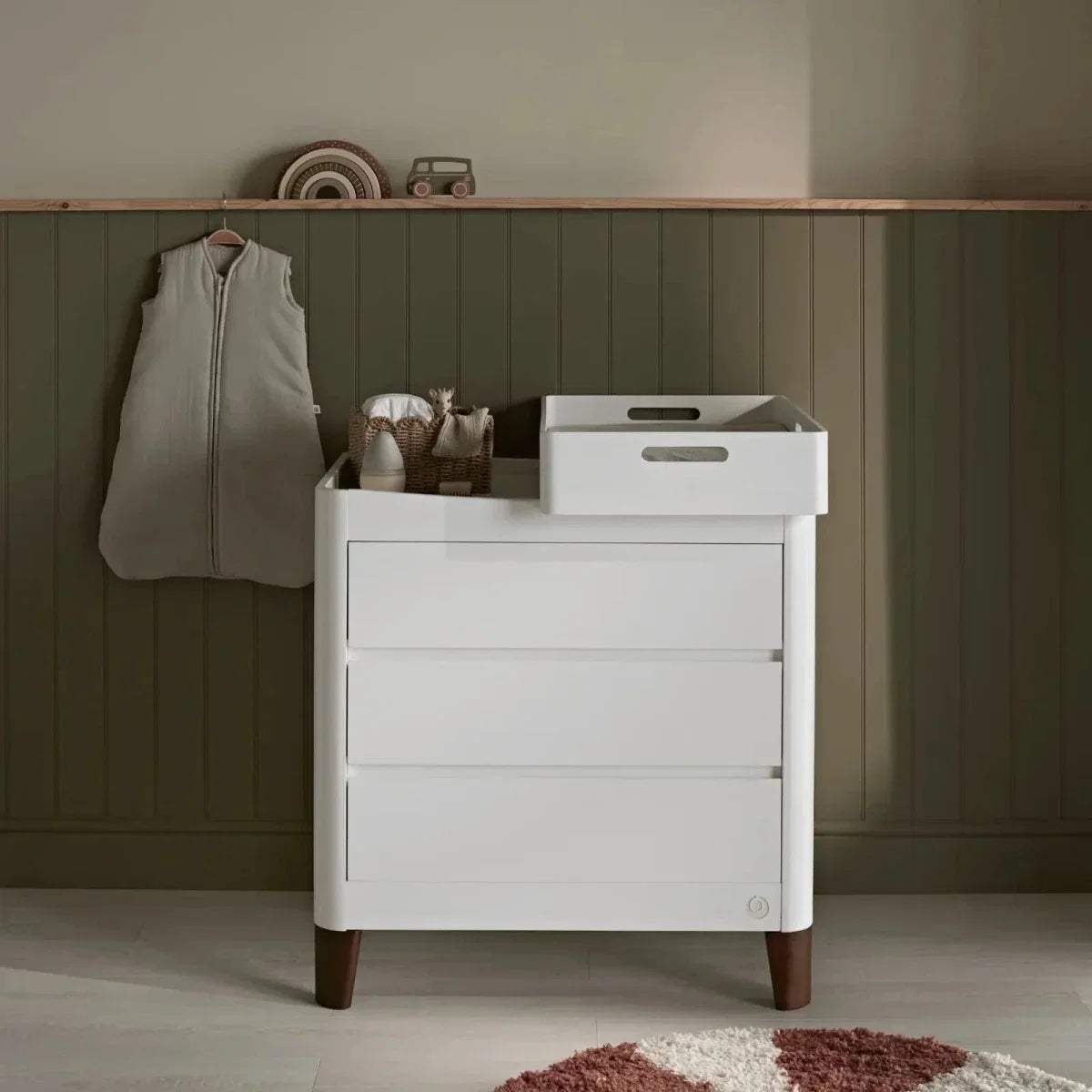 White baby dresser with drawer storage and walnut legs