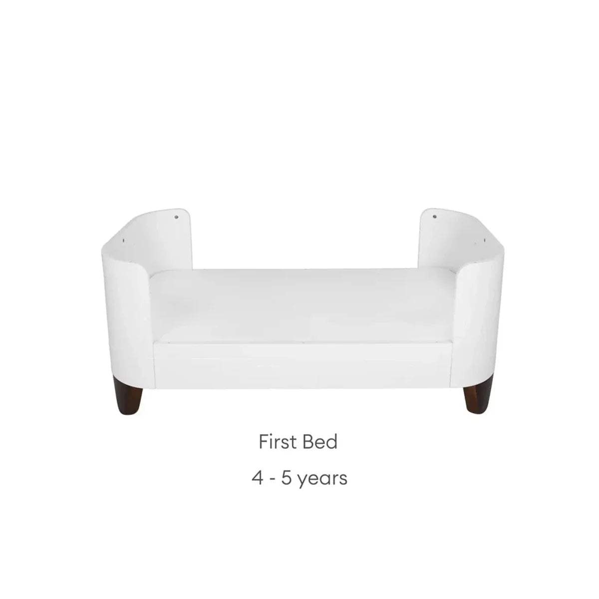 White first bed with rounded armrests, low back, and short legs
