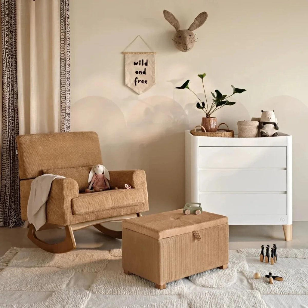 Caramel corduroy ottoman footstool with square padded top and short wooden legs.