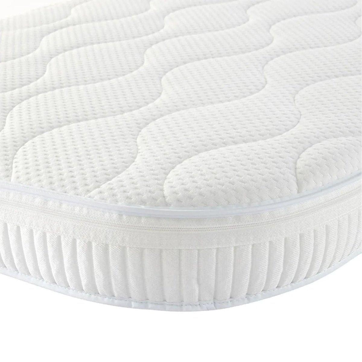 White cot mattress with quilted top and pleated fitted skirt, rounded corners