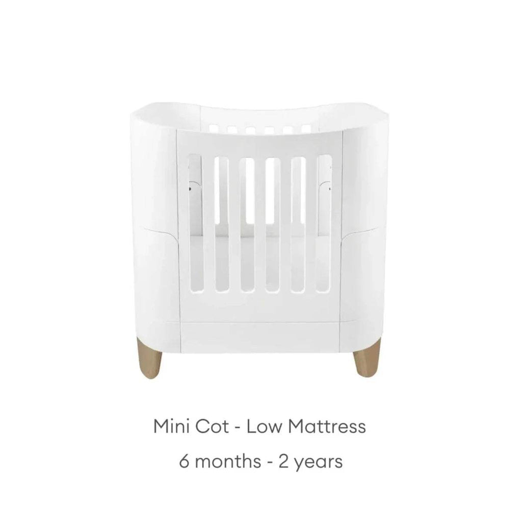 White mini cot with low mattress position, front view