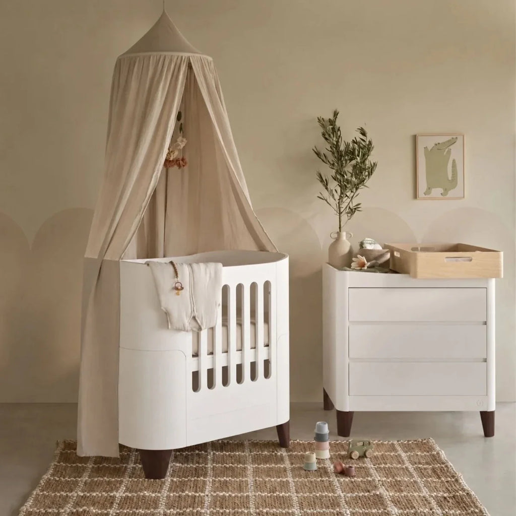 White mini cot with canopy, plus matching white dresser with walnut legs and top