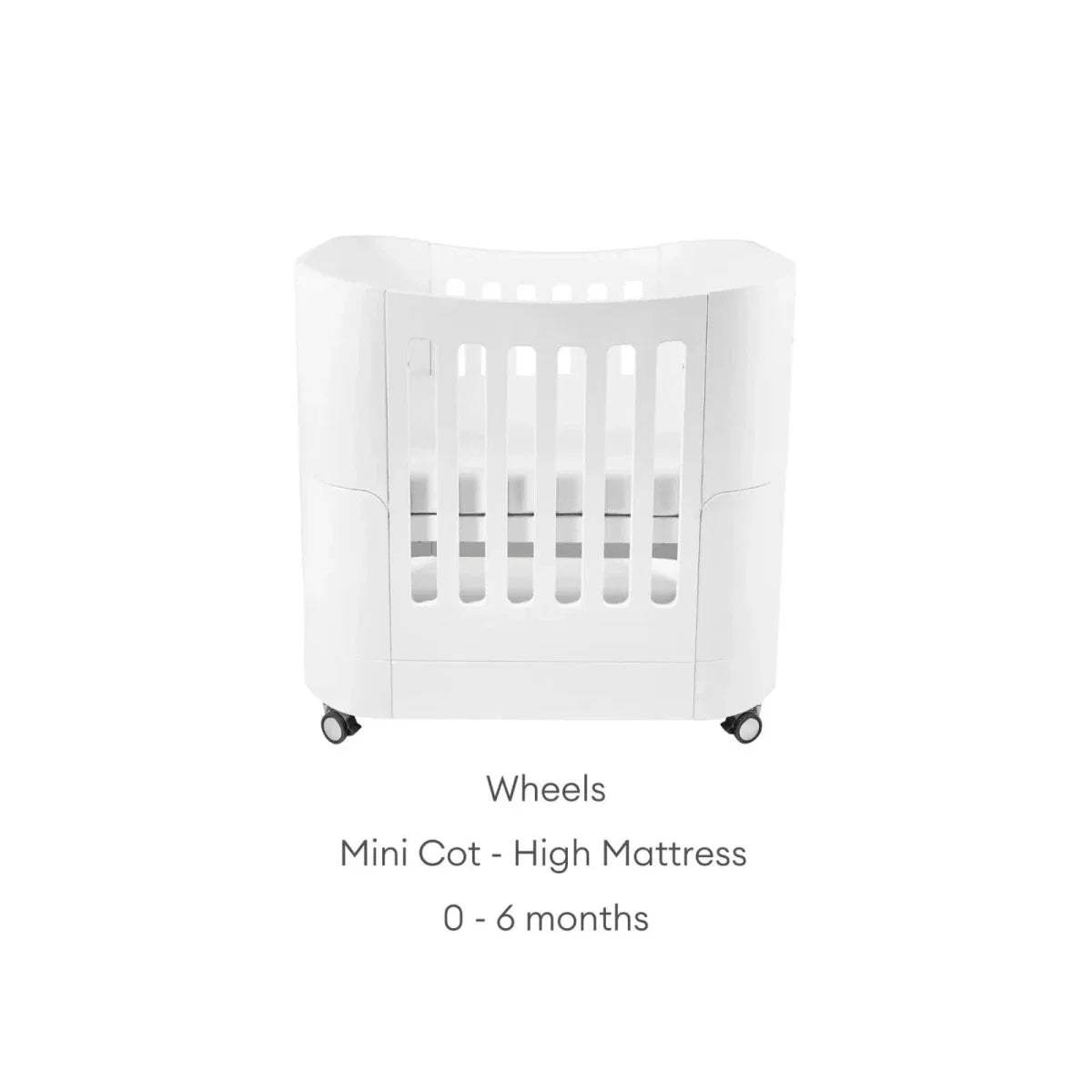 White mini cot bed with wheels, curved sides, and vertical slats; high mattress.