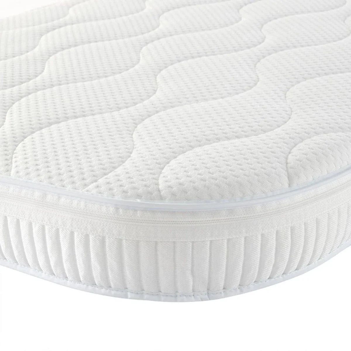 White quilted baby mattress pad with textured surface and fitted skirt