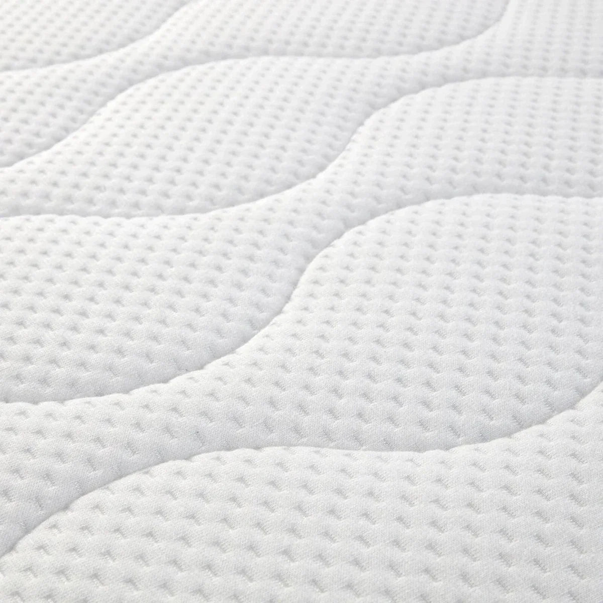 White quilted baby mattress pad with detailed dotted texture and wavy stitching