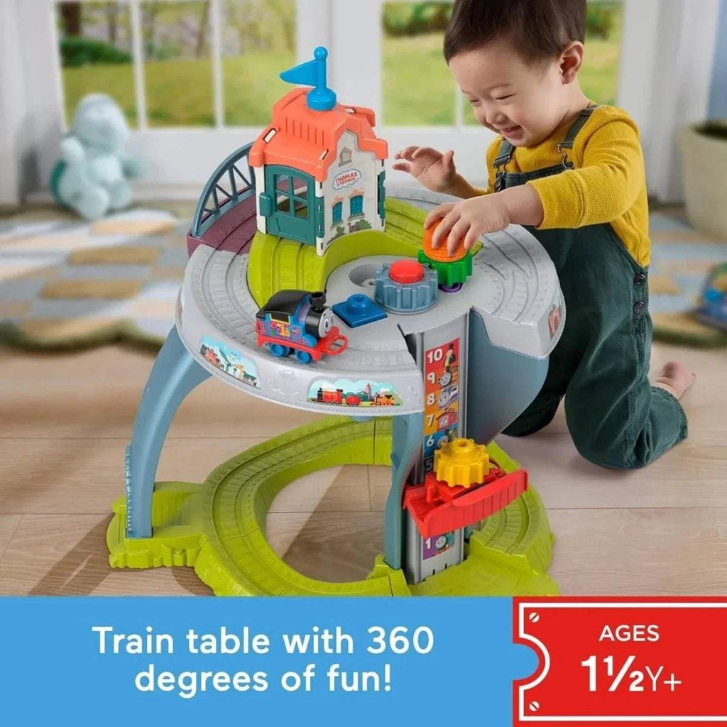 Kids train table with Thomas-style orange locomotive on circular track and rider controls