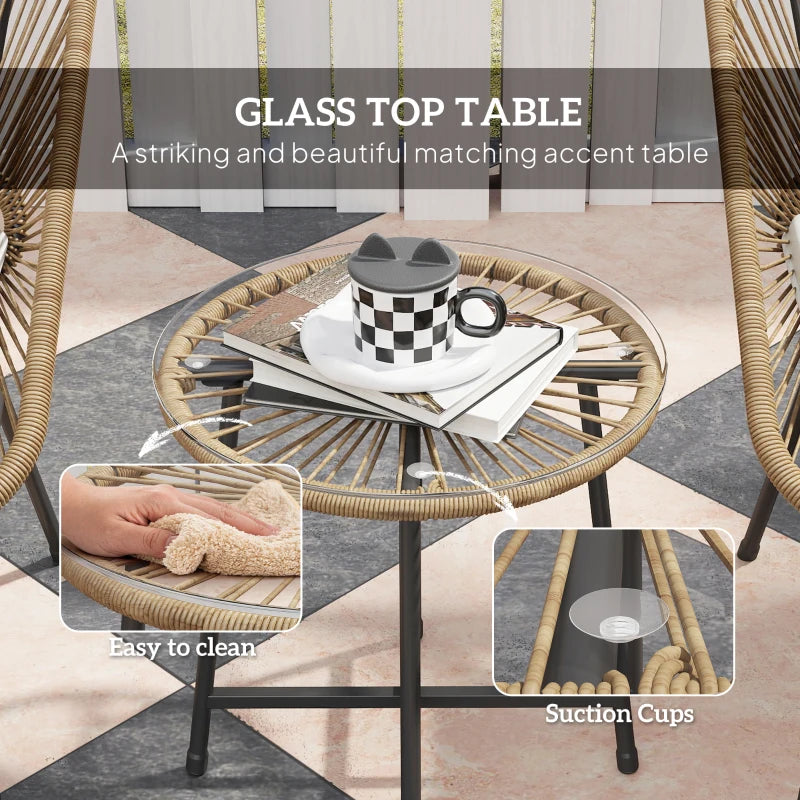 Round rattan accent table with glass top and suction feet, woven frame