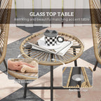 Round rattan accent table with glass top and suction feet, woven frame