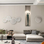 Silver round wall mirrors with abstract metal wire loop frames arranged on wall