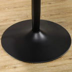 Black round pedestal dining table base with central leg on flat floor surface