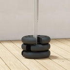 Dark gray tent leg base weight set stacked under a vertical canopy pole