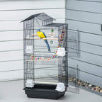 Black bird cage with a perch, hanging bead toy, and yellow bird