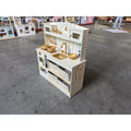 Cream kids play kitchen toy with side access panels, sink area, and stovetop