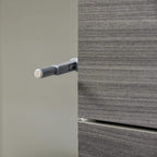 Grey push-open mechanism detail on sideboard cabinet