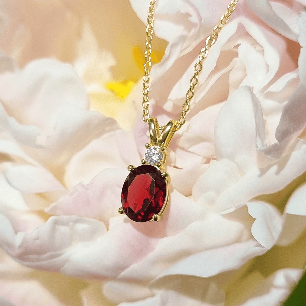 Gold-vermeil garnet pendant necklace featuring red oval garnet with crystal halo