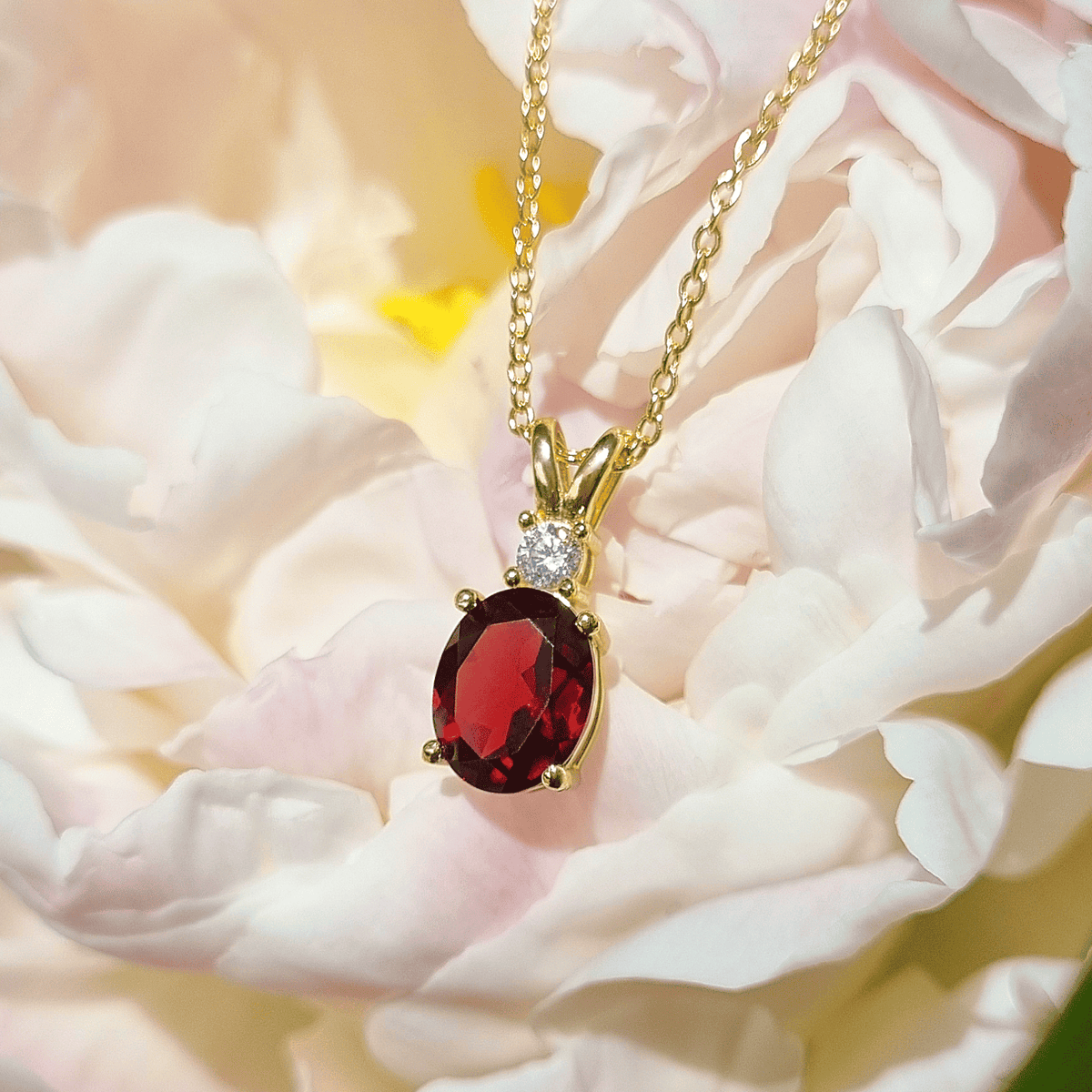 Gold-vermeil garnet pendant necklace featuring red oval garnet with crystal halo