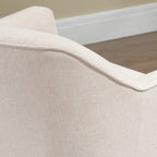 Cream upholstered armchair seat edge with curved piping detail close-up