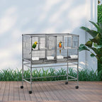 Large black parrot cage with divider, two colorful birds inside, slide tray base