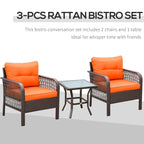 Rattan bistro set with two orange-cushioned armchairs and a small glass table