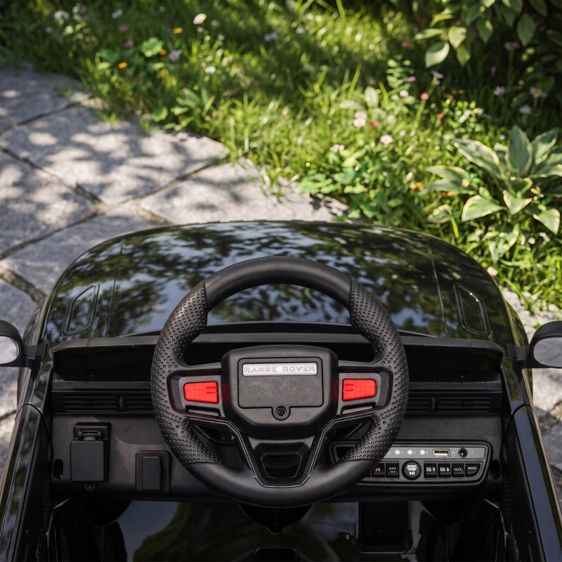 Black steering wheel and dashboard inside a licensed 12V ride-on electric car