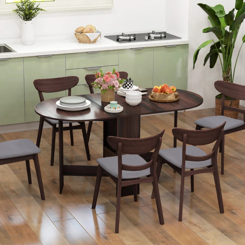 Dark brown oval folding dining table with drop-leaf top, styled with chairs