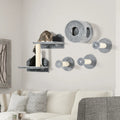 Grey wall-mounted cat tree with round tunnel, perches, and two cats on posts