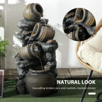 Close-up of dark grey fountain with stacked jars and flowing water stream, gold accents