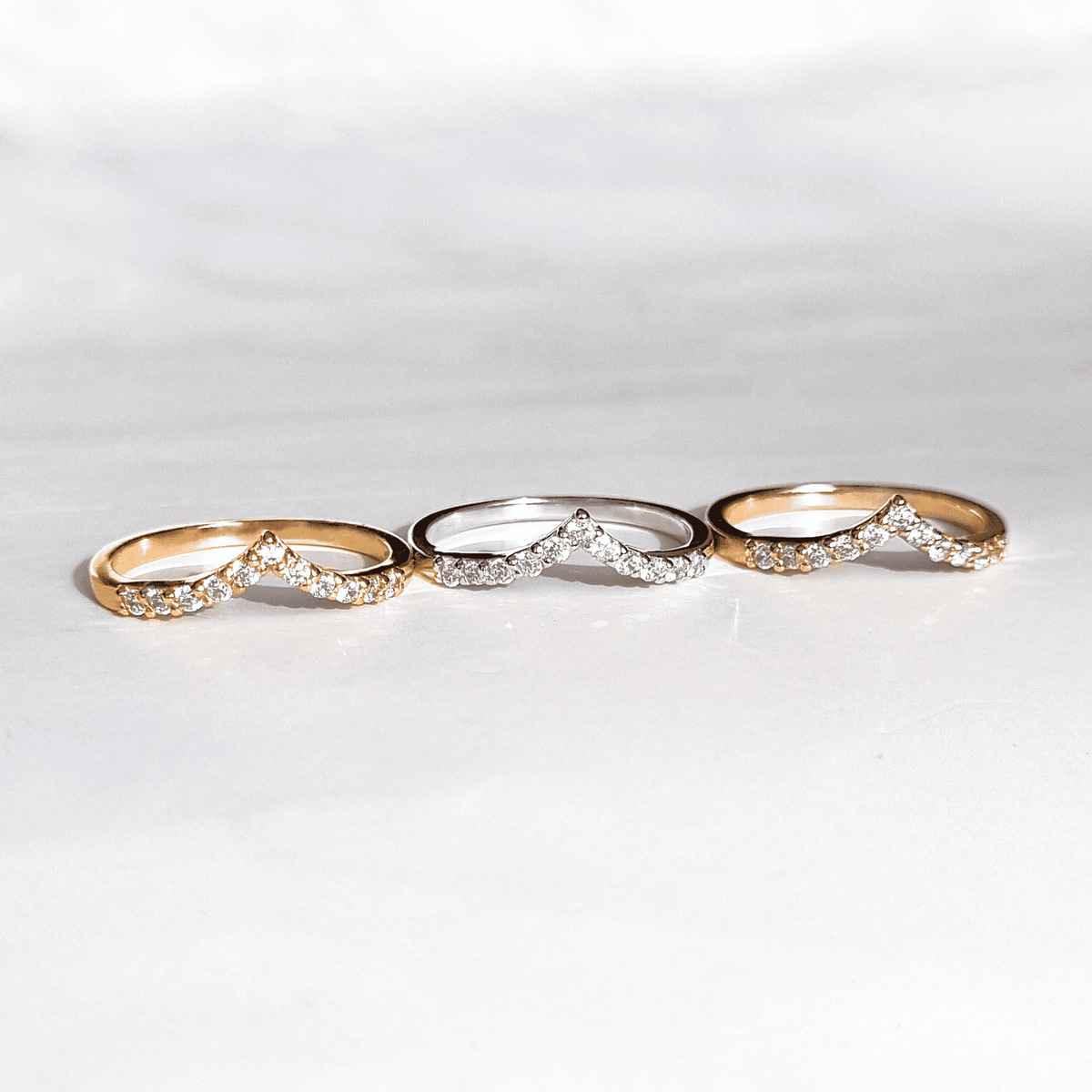 Wishbone curved eternity rings in gold and silver with pavé stones