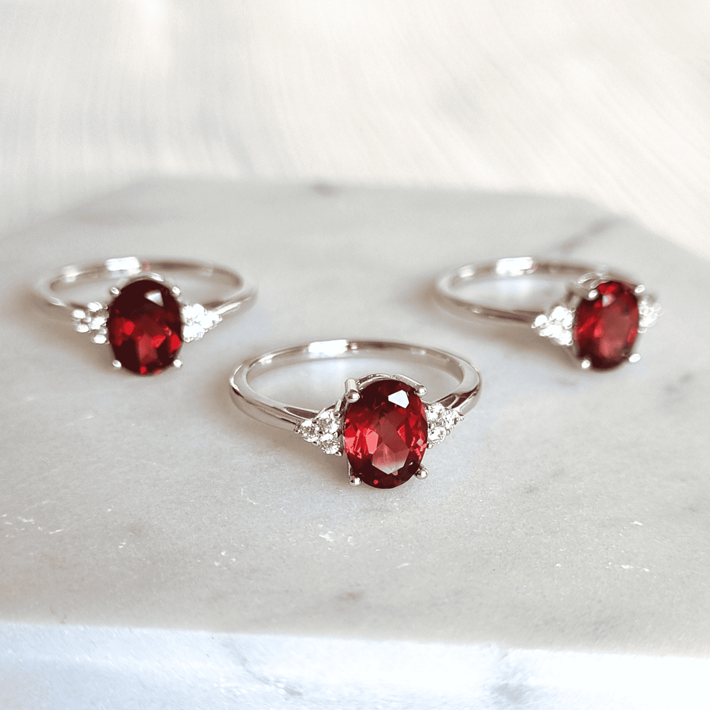 Sterling silver rings with oval garnet and side stones
