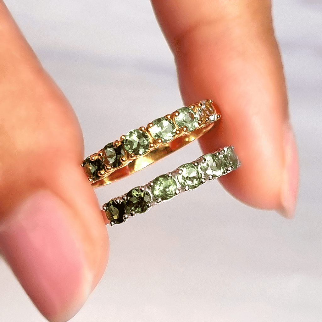 Gold-tone eternity band with green tourmaline stones, shown with matching band