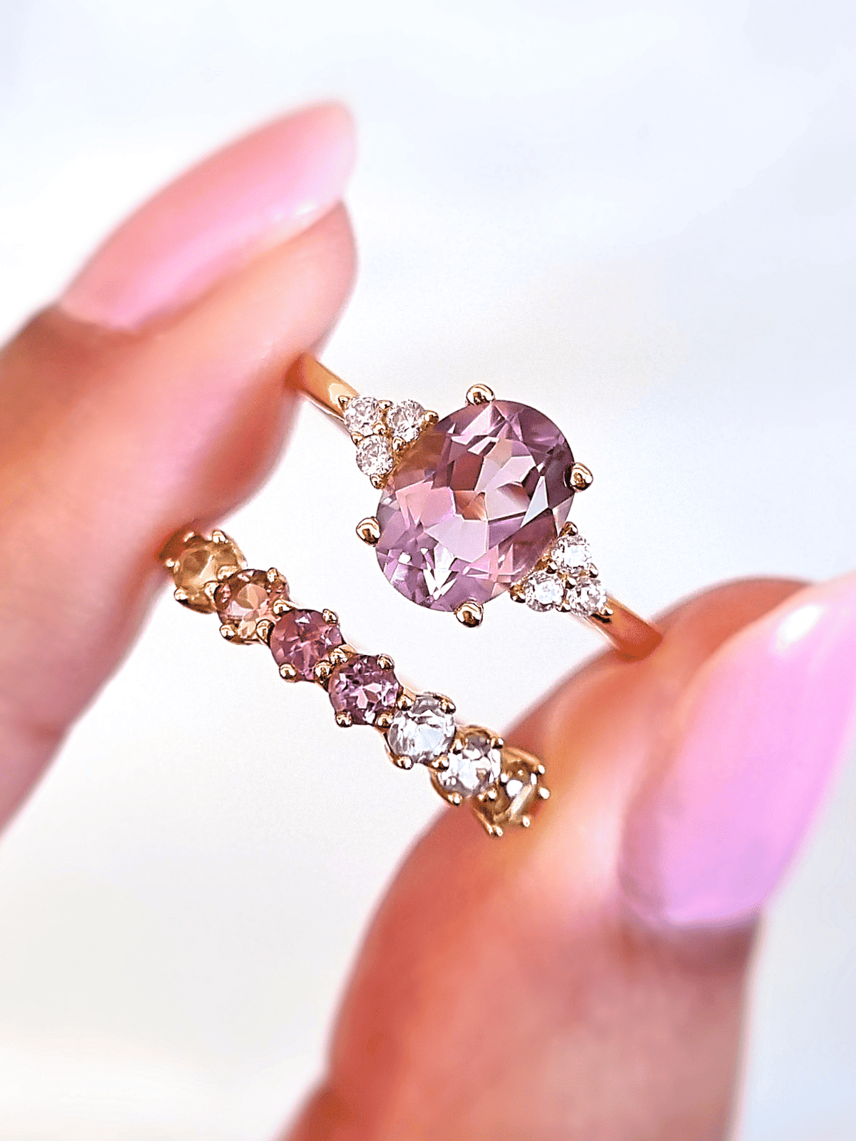Lavender amethyst ring with oval center stone and clustered side stones, gold-tone