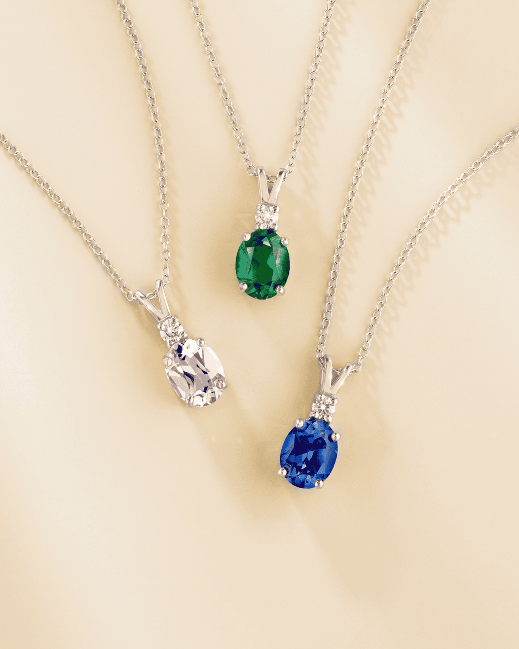 Sterling silver pendant necklace with oval gemstone pendants in different colors