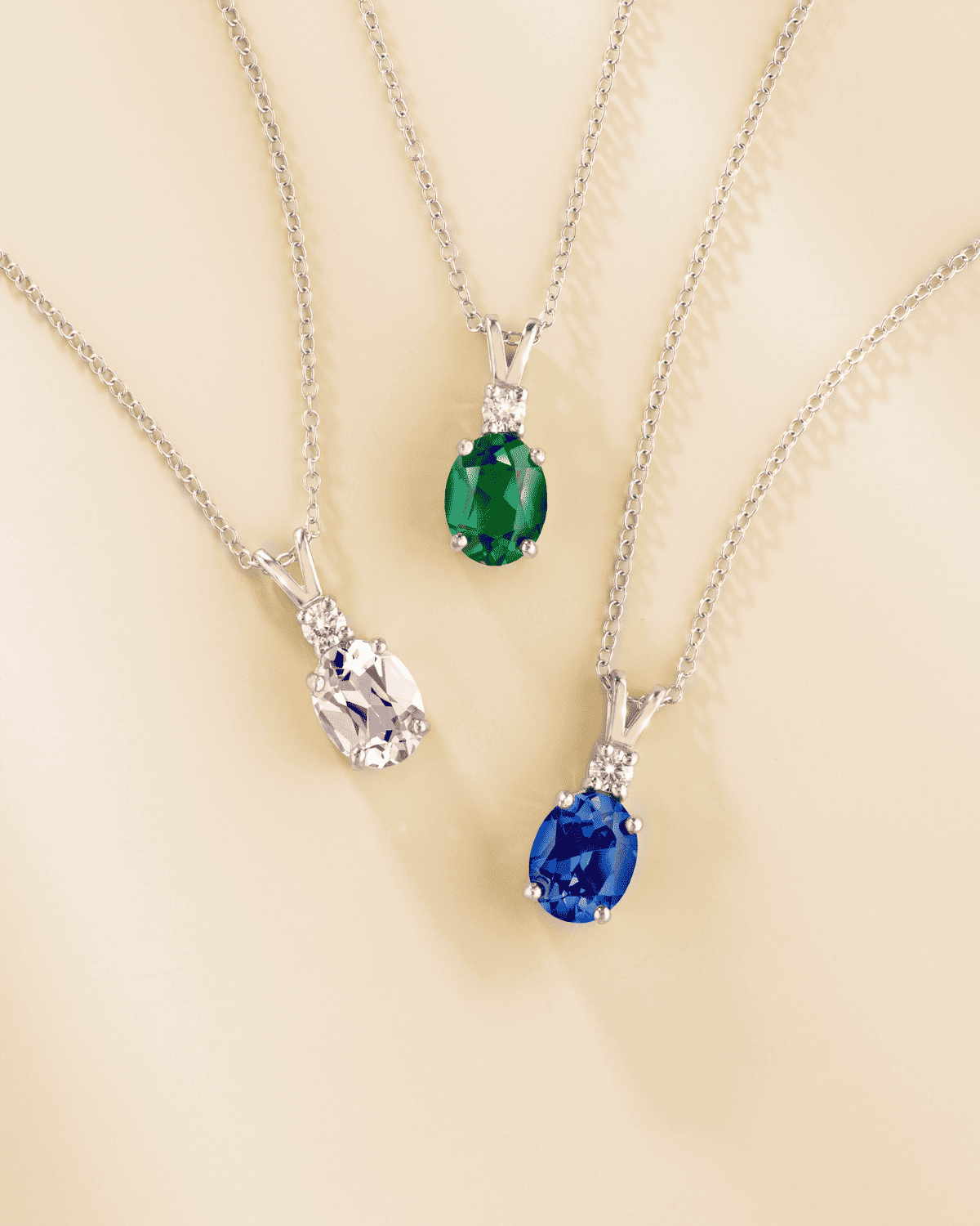 Sterling silver pendant necklace with oval gemstone pendants in different colors