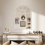 White arched grid mirror on wall with window-style pane grid and framed decor