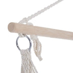 Close-up of wooden hanging bar and metal ring with braided rope suspension