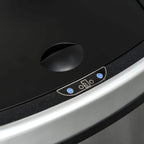 Close-up of control buttons and indicator lights on black top of silver bin