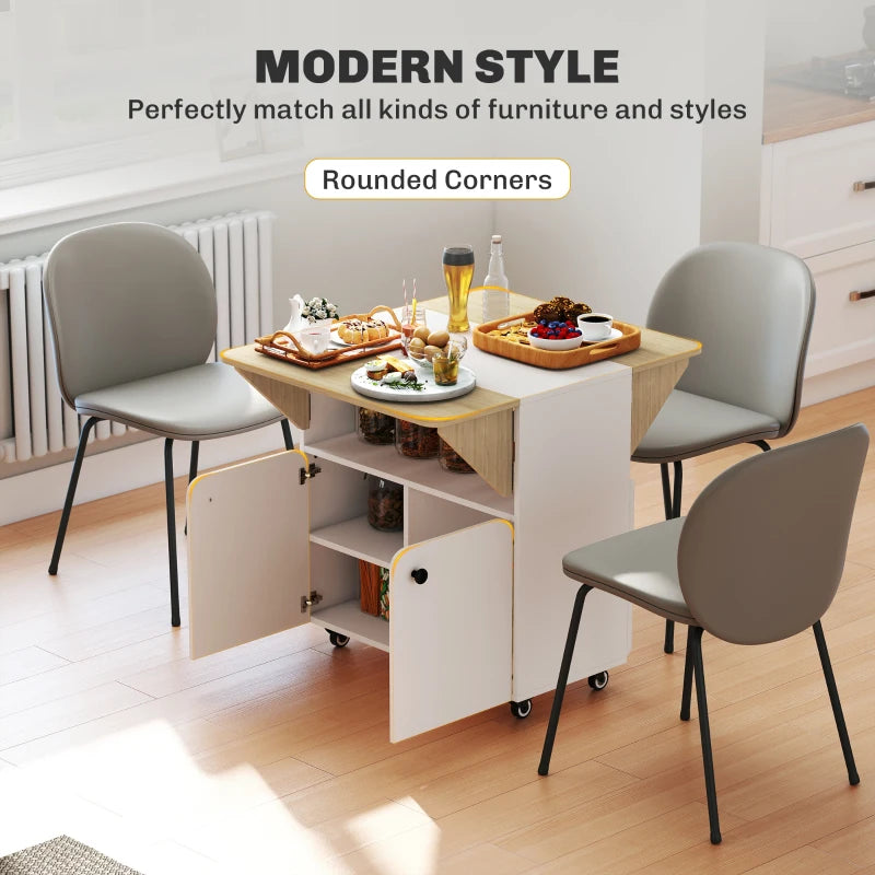 White drop-leaf dining table with open center and rounded cabinet base, on casters