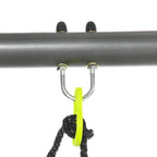 Metal swing set rope attachment with U-bolts and green connector loop.