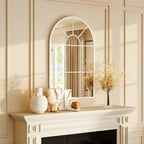 White arched grid mirror above console table with arched pane grid design