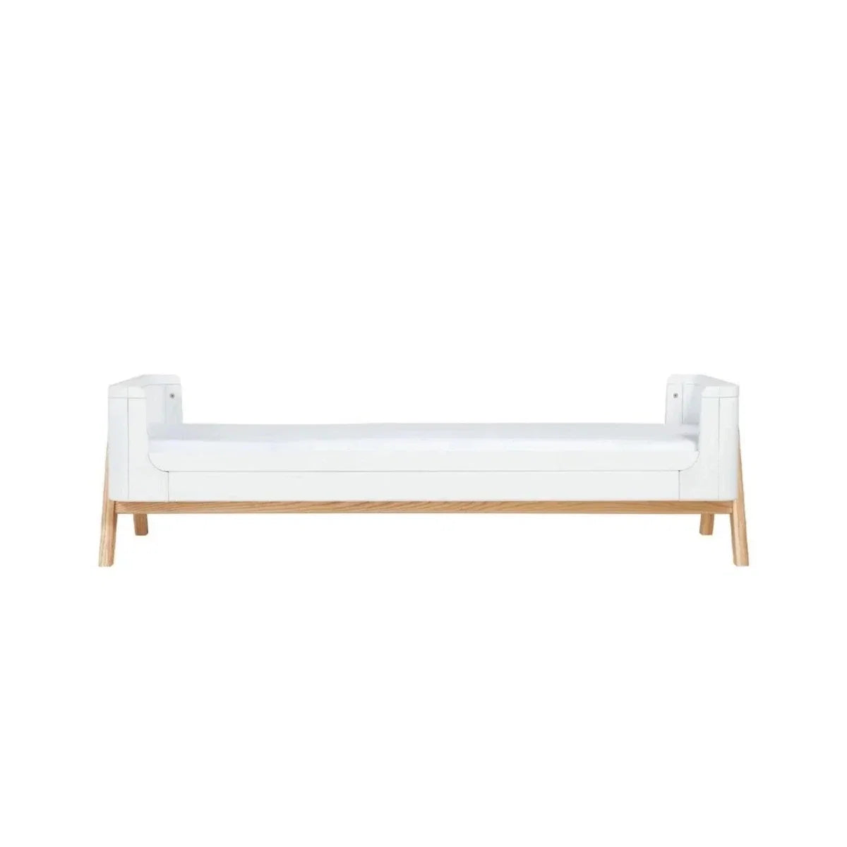 White junior bed extension with mattress, solid side panels and light wood legs