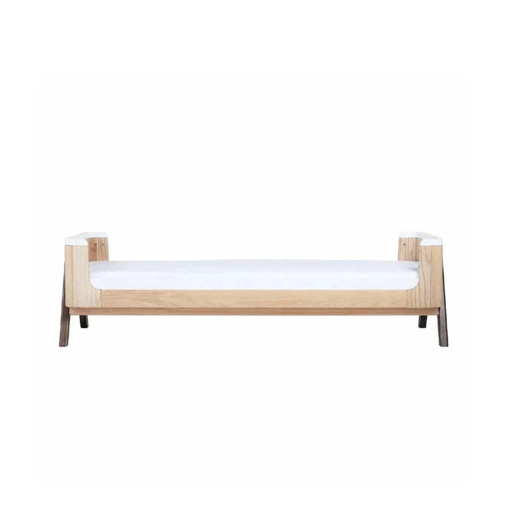 Junior bed extension with natural wood posts and white rail, no bedding