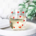 Stemless glass with red heart print, transparent body and rounded rim